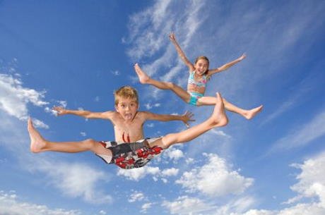kids mid-air while jumping on trampoline